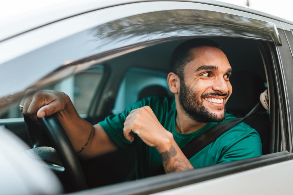 A driver setting off with the window down