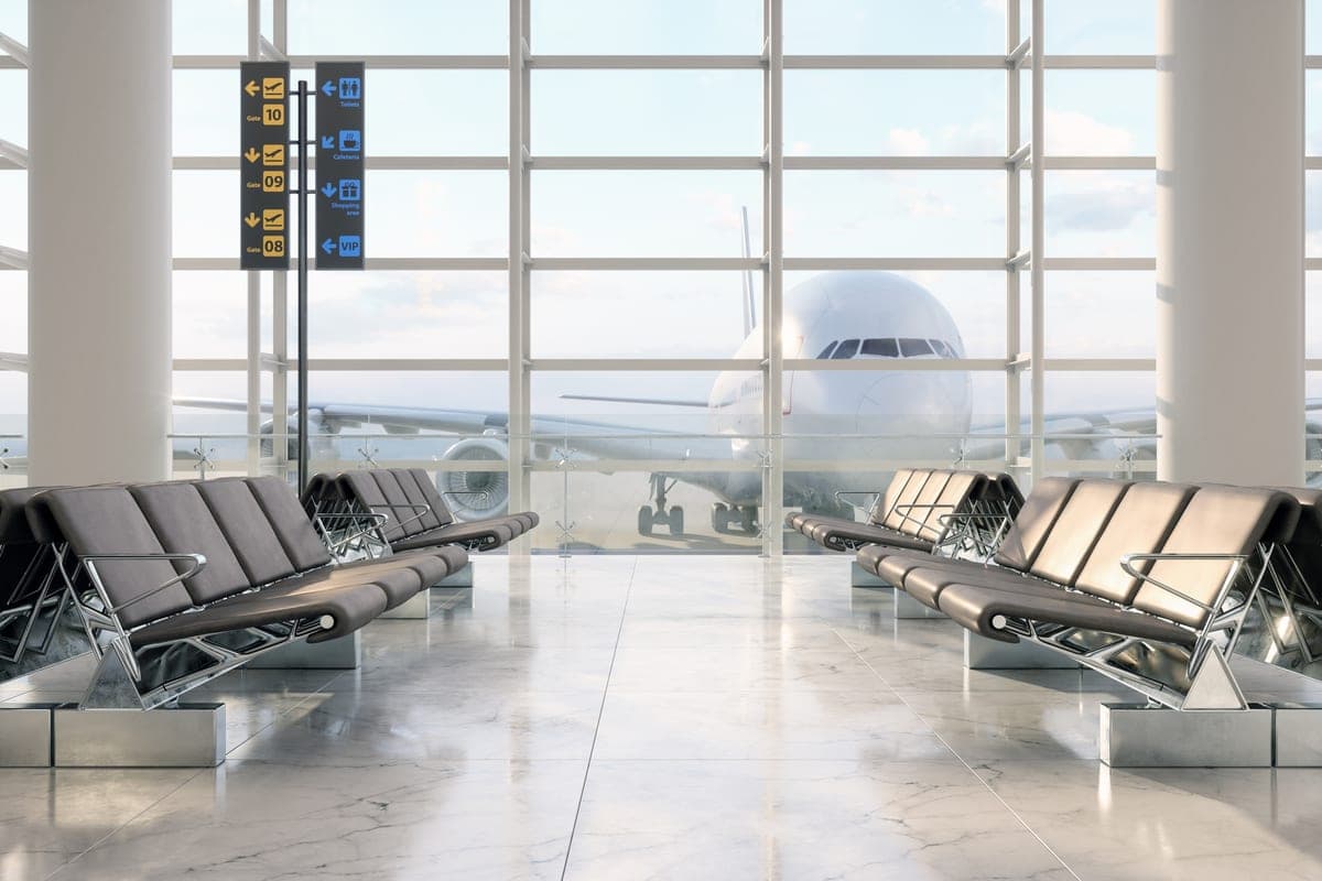 An airport terminal gate with an aircraft outside